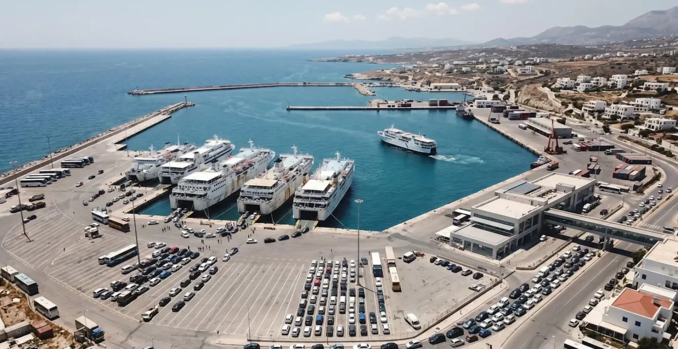 Weitwinkelaufnahme eines modernen mediterranen Fährhafens von oben, leerer Kai-Bereich mit angelegten Schiffen, zeitgenössische Hafenarchitektur bei Tageslicht